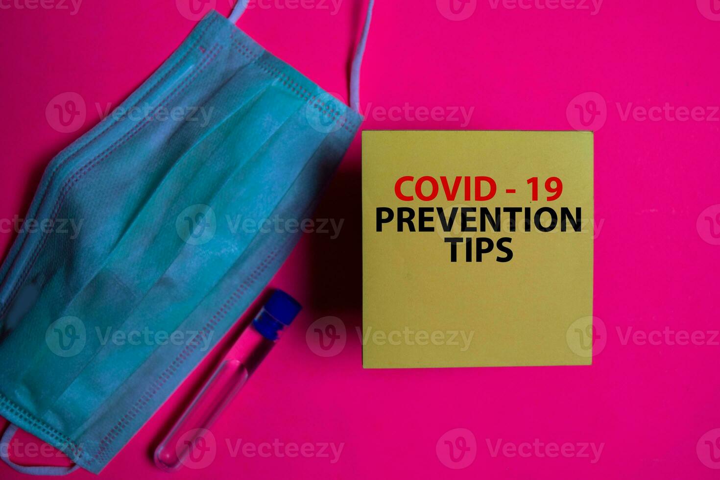 Covid - 19 Prevention Tips write on a sticky note isolated on Office Desk. Healthcare Medical concept photo