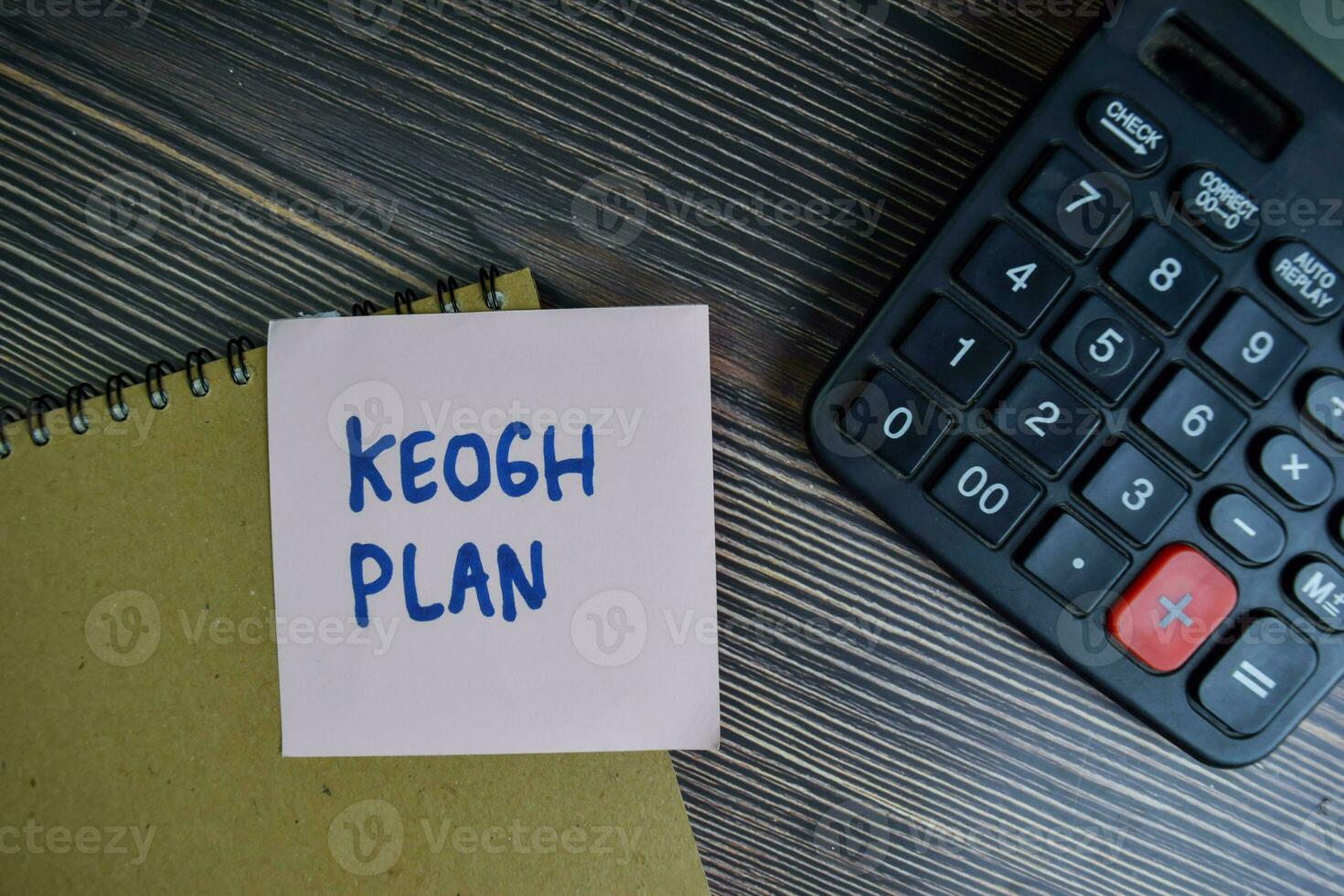 Keogh Plan write on sticky notes isolated on Wooden Table. photo