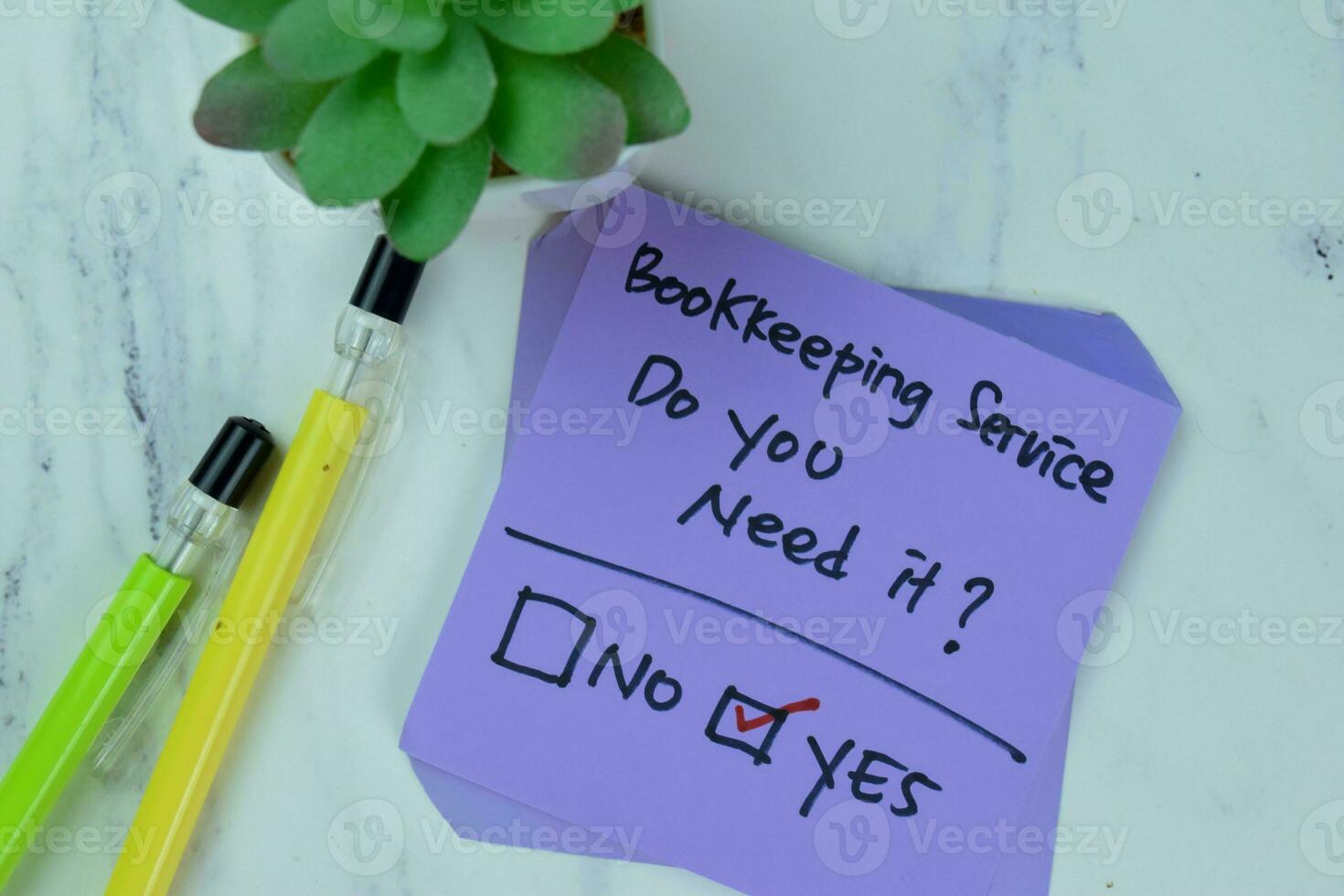 Concept of Bookkeeping Service, Do you need it no or yes write on sticky notes isolated on Wooden Table. photo