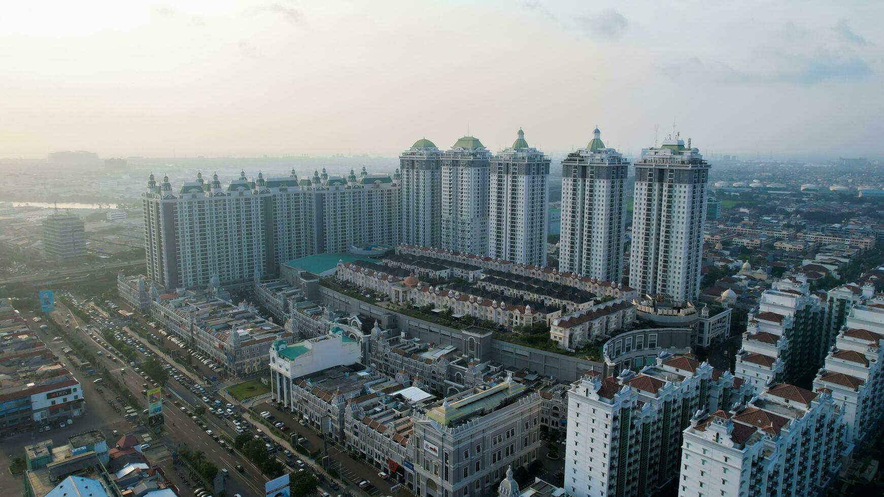 Aerial view of new green urban landscape in the city. Cityscape of a residential area with modern apartment buildings when sunset with noise cloud. Jakarta, Indonesia, Juni 23, 2022 photo
