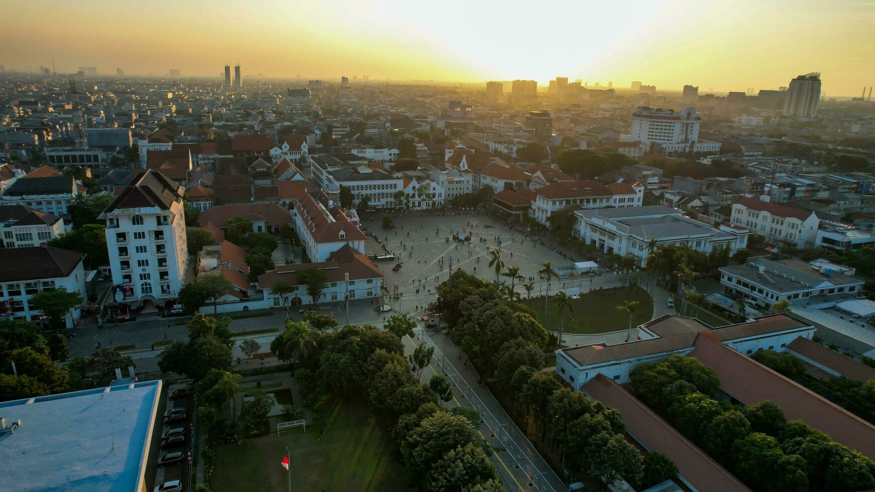 Aerial View. Fatahilah museum at Old City at Jakarta, Indonesia. With Jakarta cityscape and noise cloud when sunset. Jakarta, Indonesia, August 30, 2022 photo