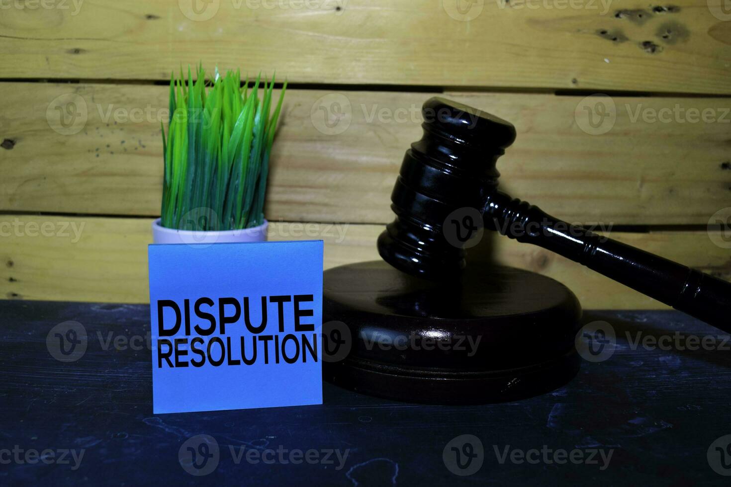 Dispute Resolution write on sticky note and gavel. Wooden background. Law concept photo