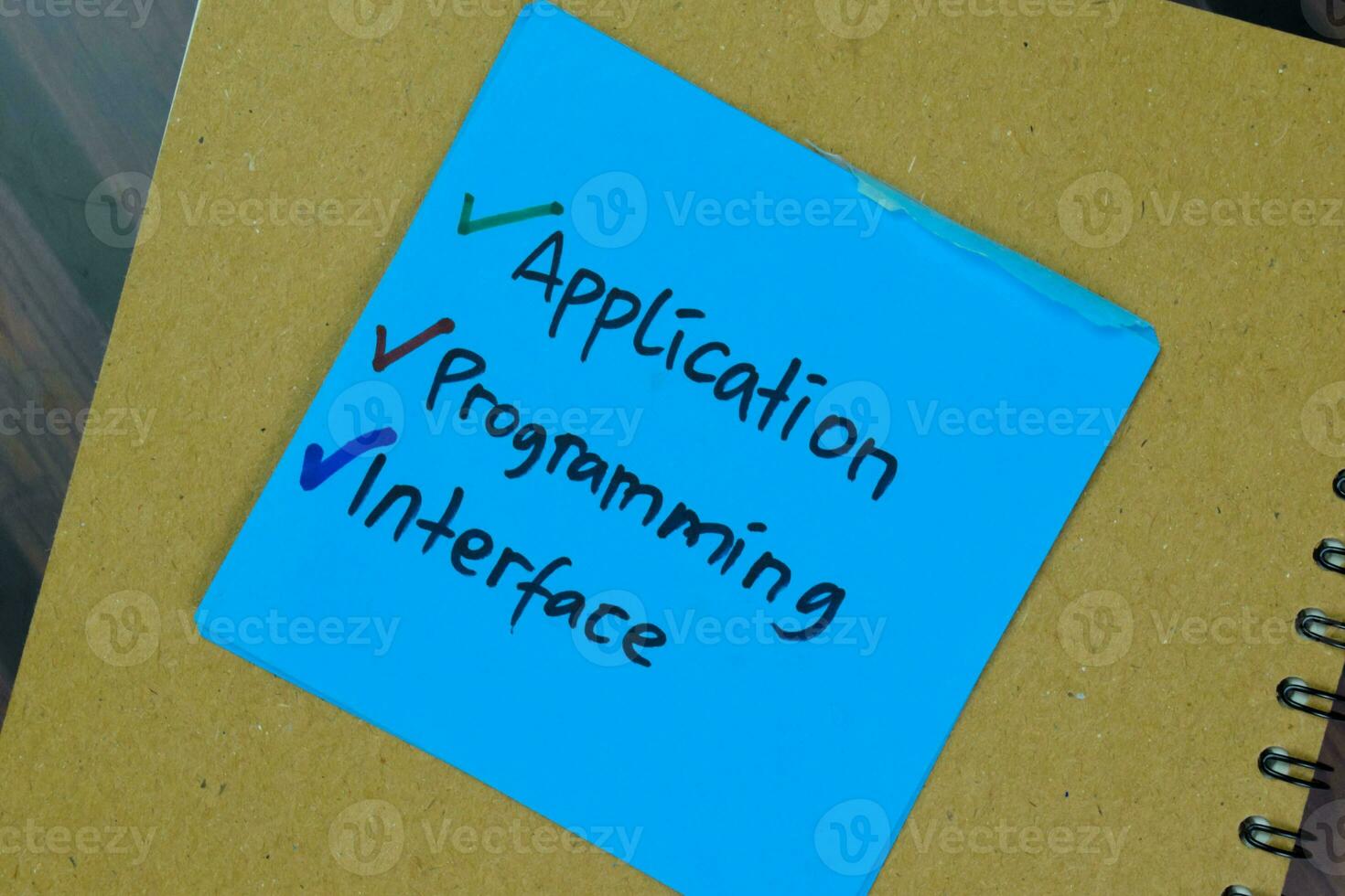 Concept of Application, Programming, and Interface write on sticky notes isolated on Wooden Table. photo