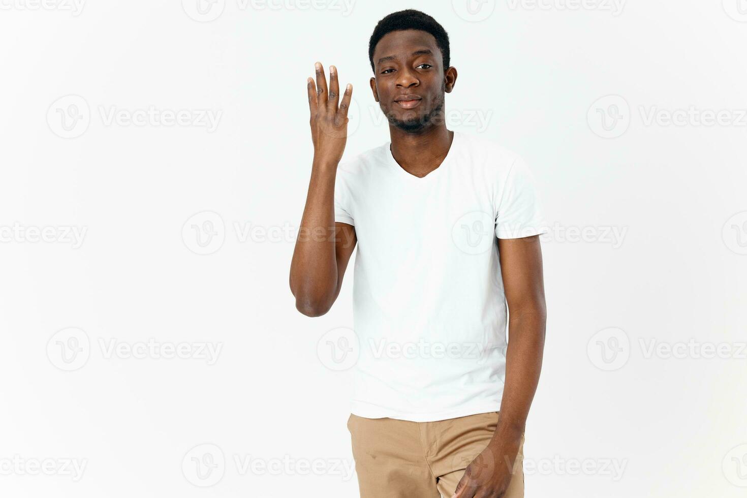 man of african appearance gesturing with hands in white t-shirt photo