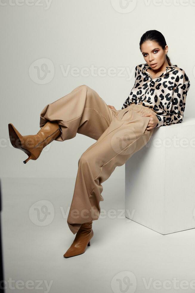 woman in fashion clothes leopard shirt brown boots glamor photo