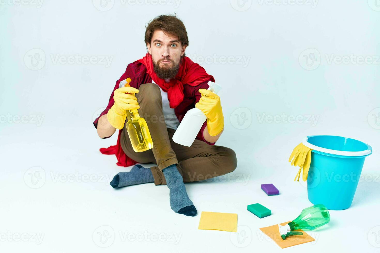 Man on the floor cleaning the house with cleaning supplies photo