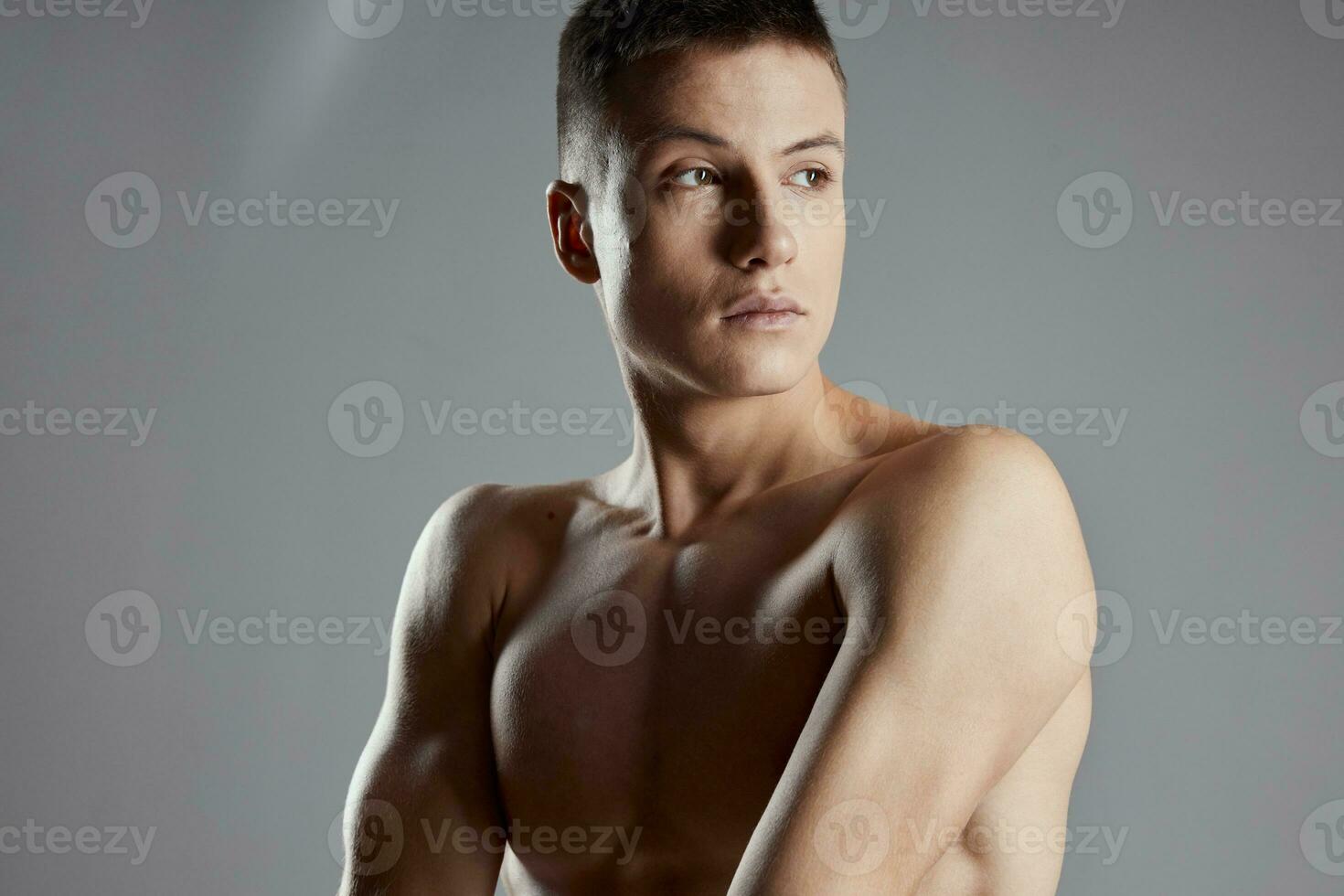 athletes with pumped up muscles Hands from cubes on the press on a gray background close-up photo