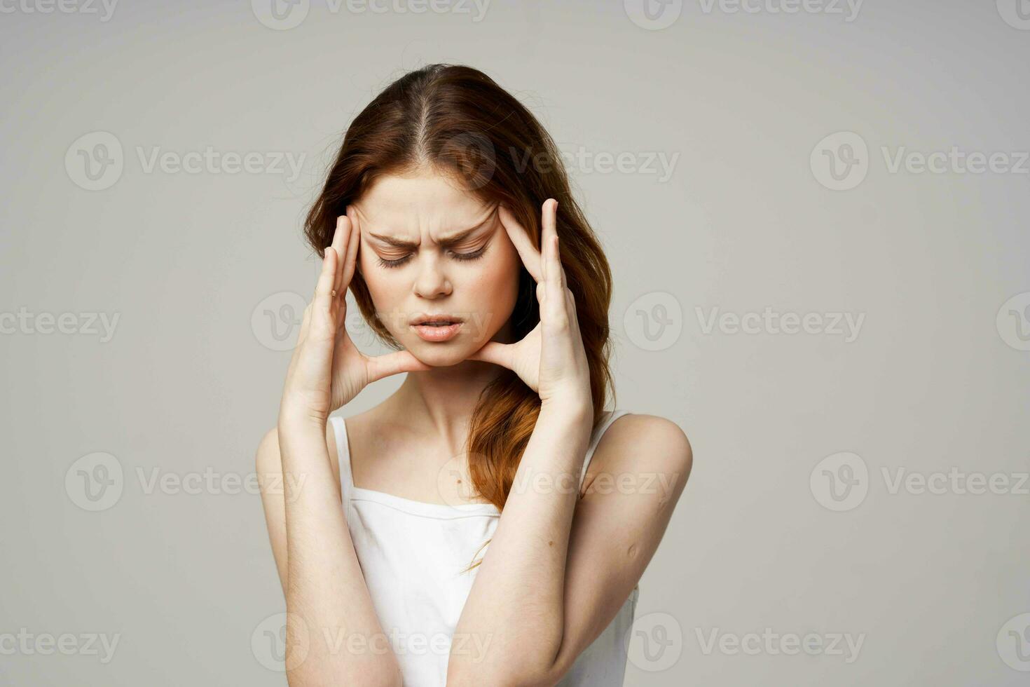 woman in white t-shirt depression symptoms headache light background photo