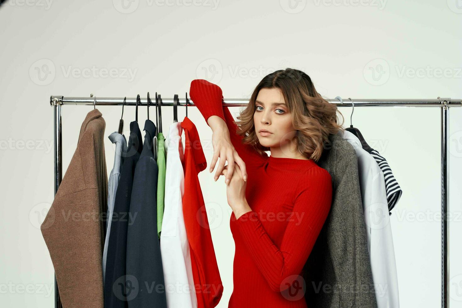 pretty woman next to clothes fashion fun retail isolated background photo