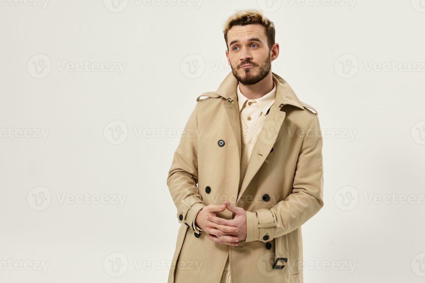 emotional man in beige coat autumn style studio cropped view photo