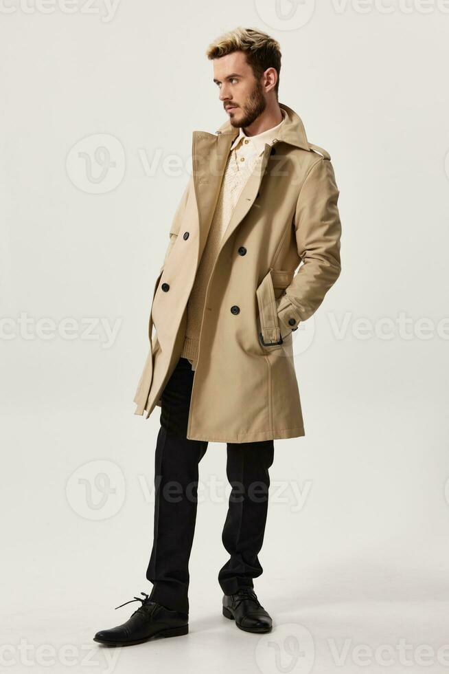 man in beige coat shirt pants and fashion shoes photo