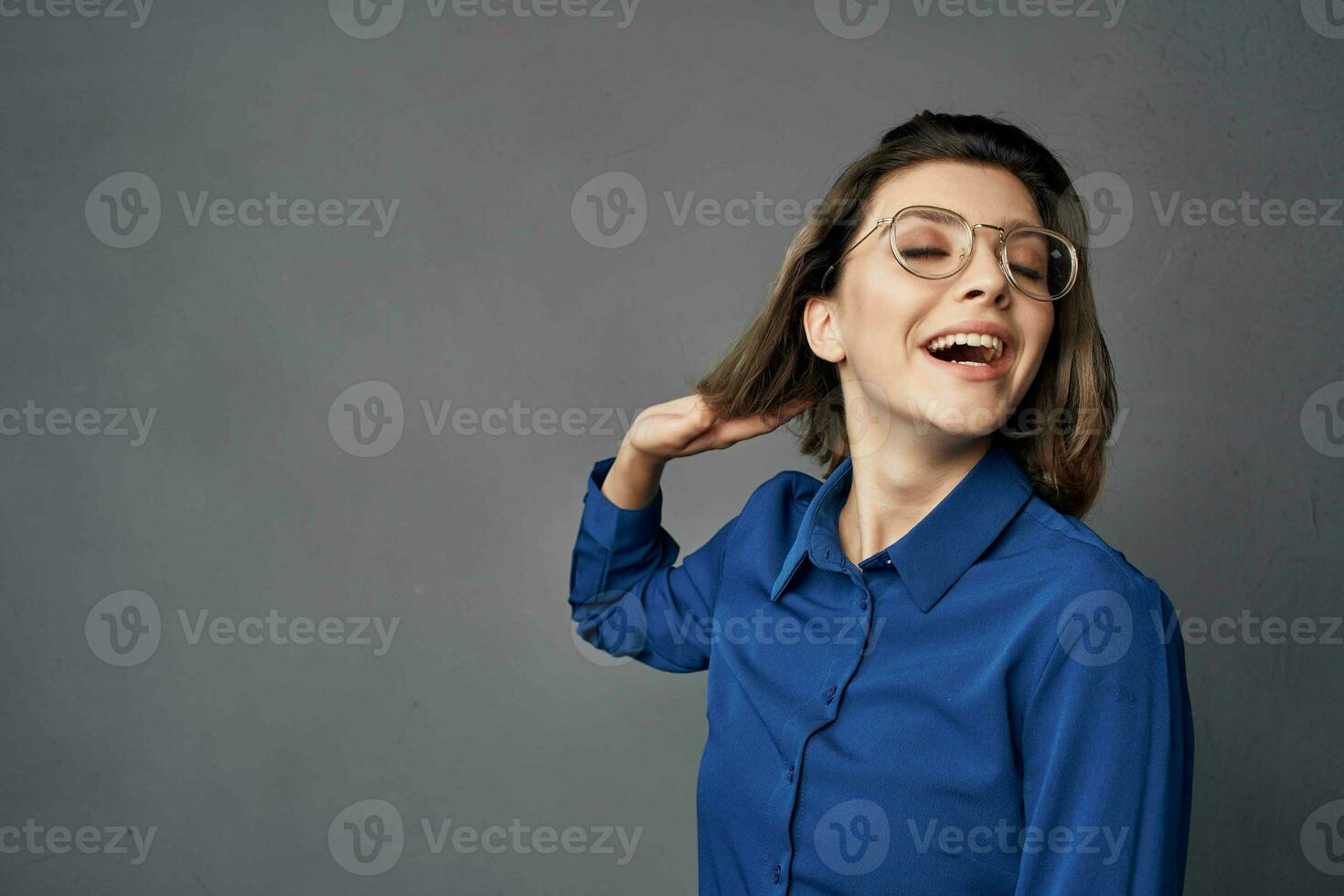 woman in blue shirt wearing glasses elegant style isolated background photo