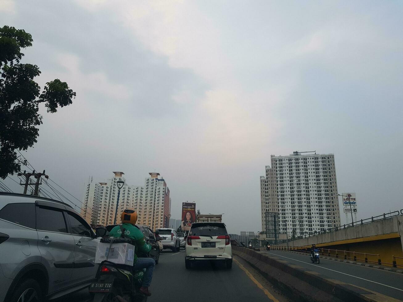 Bekasi, Indonesia in March 2019. Congestion conditions that occur on one side of the flyover in East Bekasi. You can see two apartment buildings, Kemang View on the left side photo