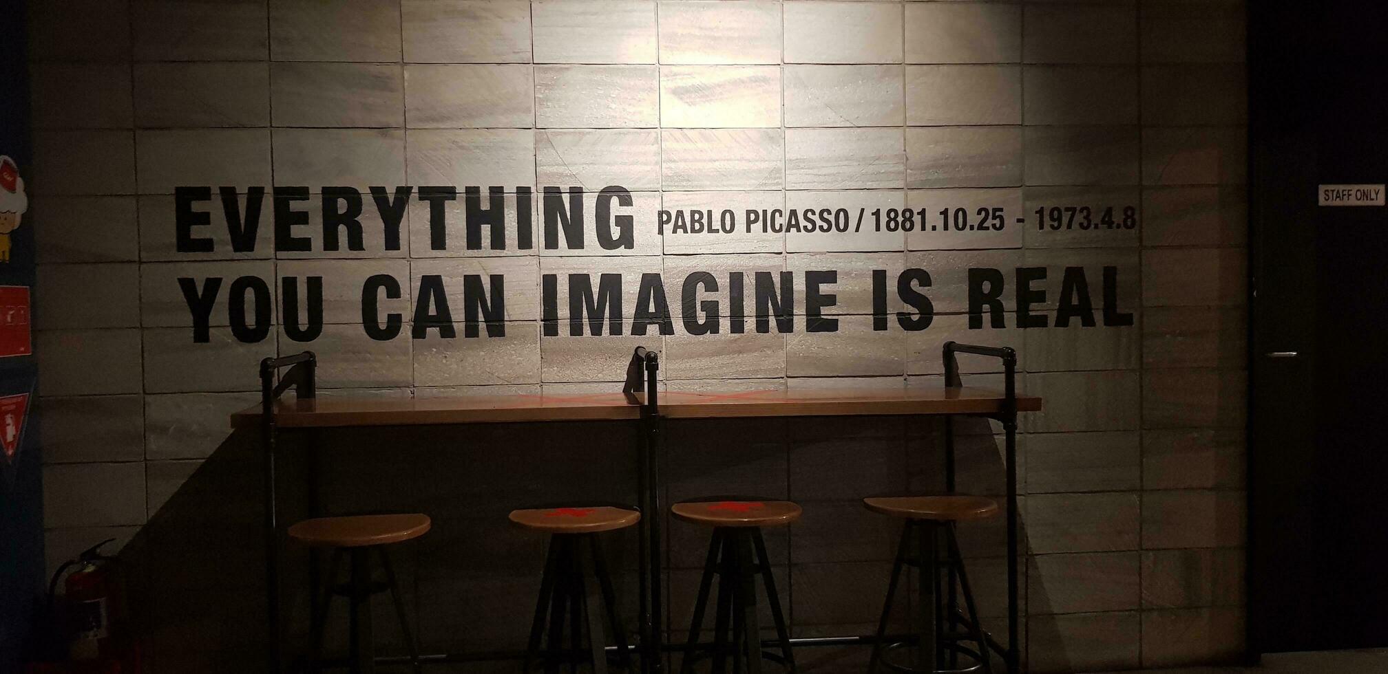 Jakarta, Indonesia in March 2019. One corner of a coffee shop that has a quote from Pablo Picasso, Everything you can imagine is real. photo