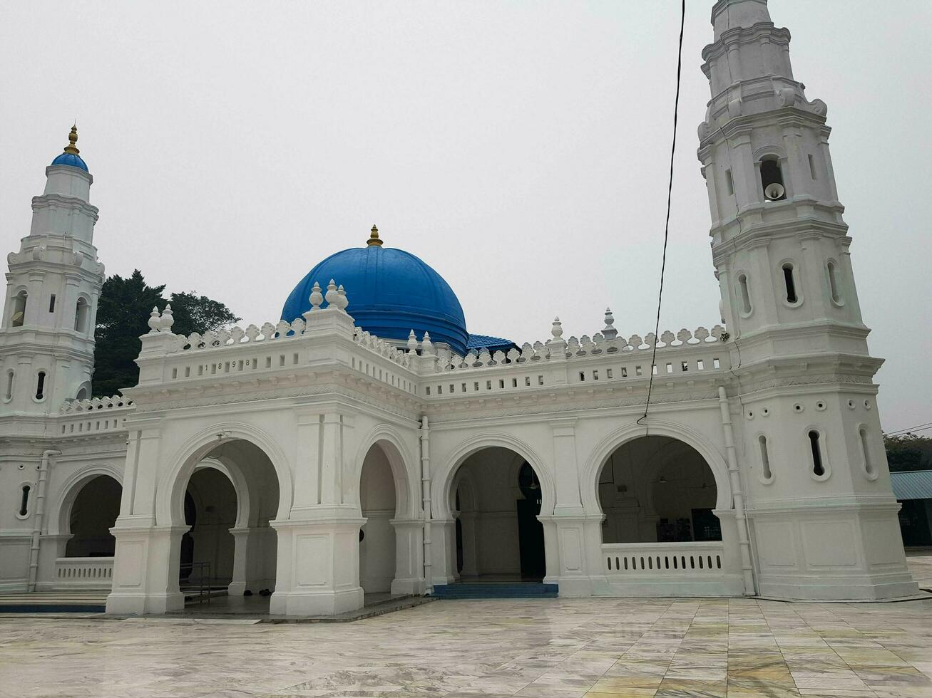 Ipoh, Malaysia in November 2019. Panglima Kinta Mosque, a white mosque with a blue dome. photo