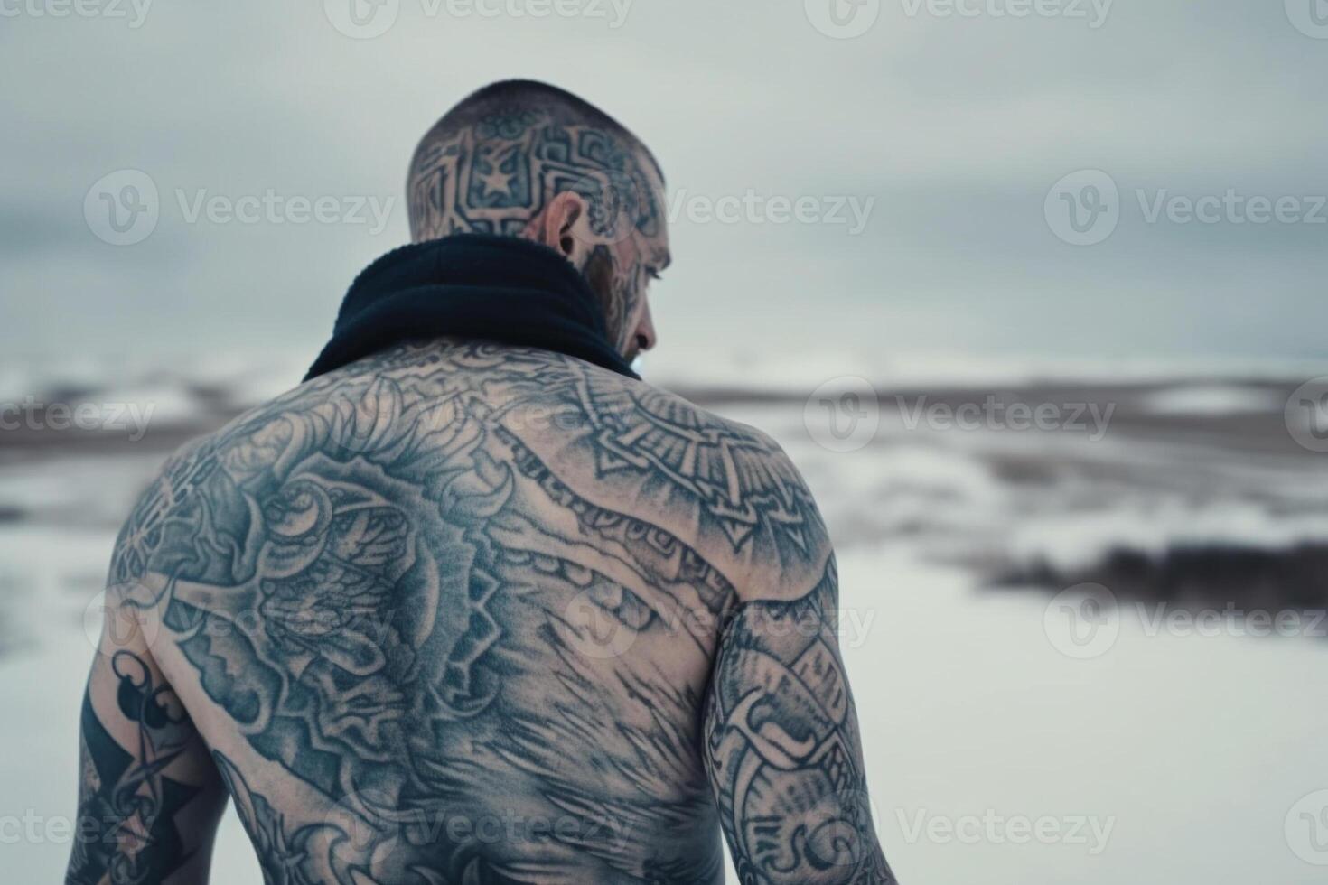 Icelandic man with his back covered in tattoos outside in frozen winter. photo