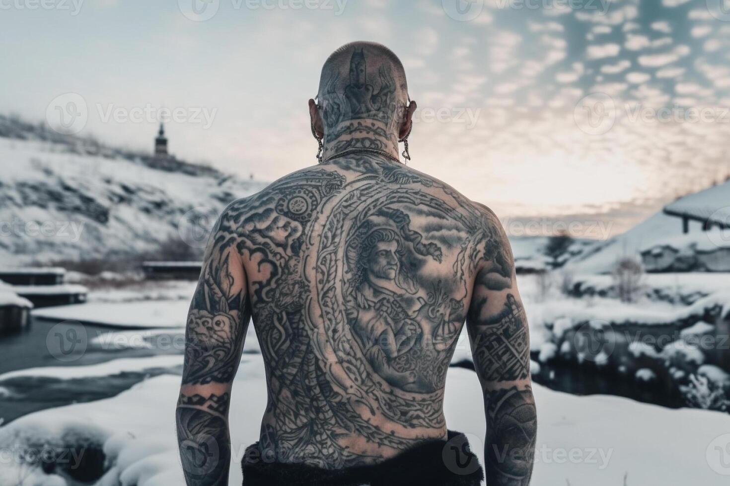 Icelandic man with his back covered in tattoos outside in frozen winter. photo