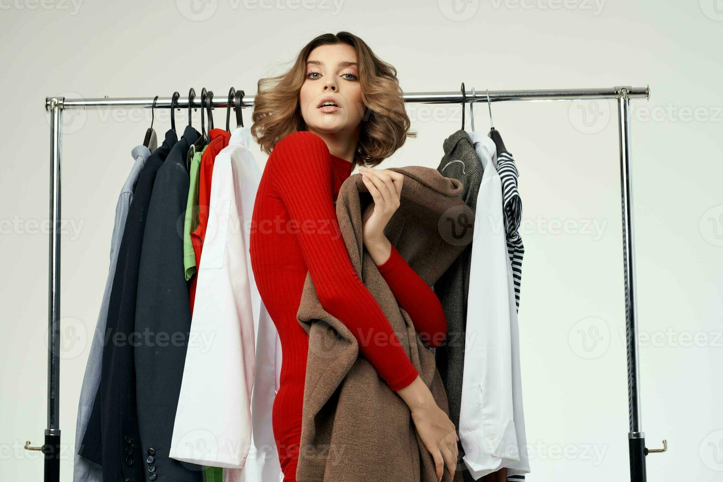 beautiful woman trying on clothes shop shopaholic light background photo