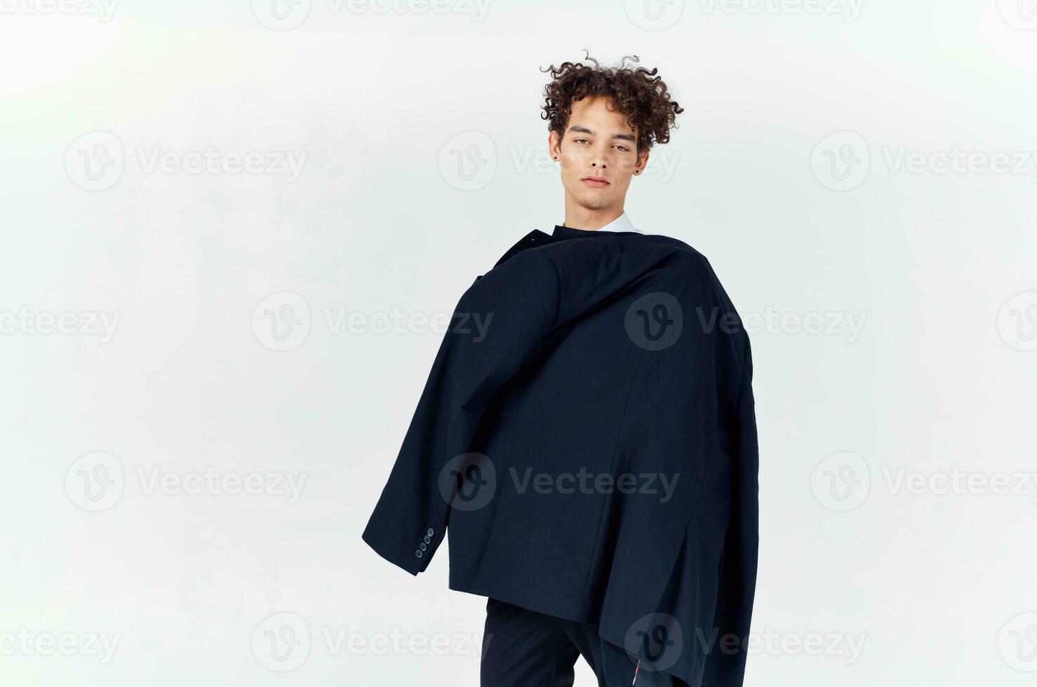 man holding a black jacket in his hands fashion modern style self-confidence studio photo