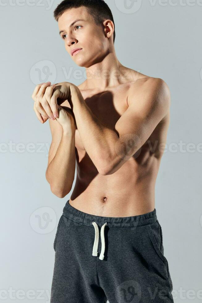 man with pumped up abs workout pants photo