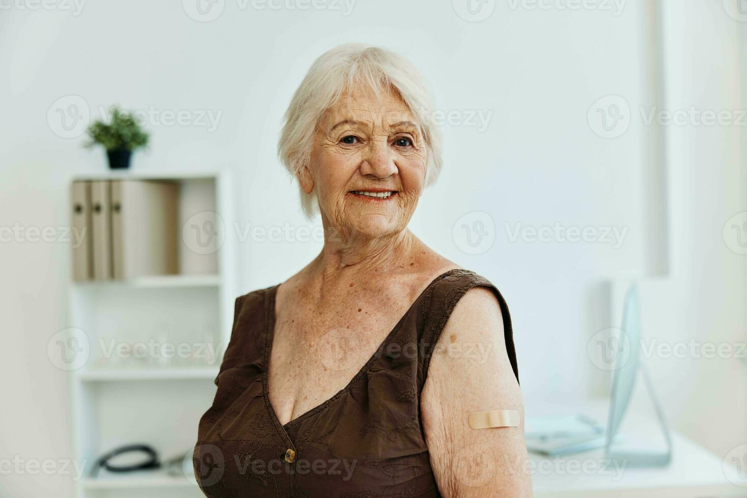 elderly woman plaster on shoulder covid passport immunization safety photo