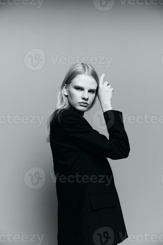 Charming young professional model puts her hand to her face cheek in the studio. The concept for the new collection. Classic black and white photo