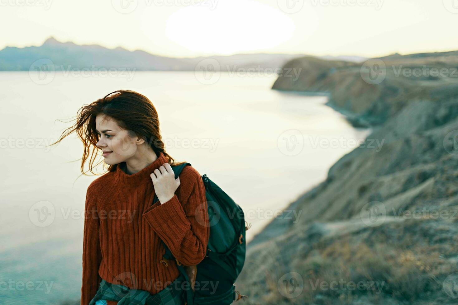 woman with backpack on her back rocky mountains landscape sea travel photo
