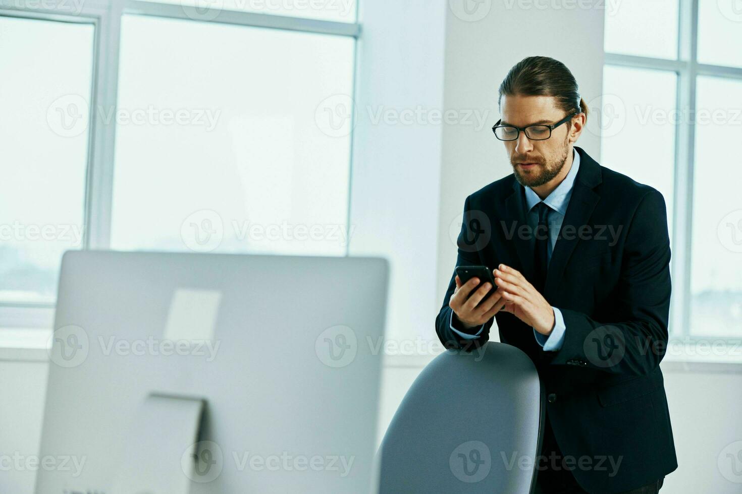 The man in a suit in the office gestures with his hands executive photo