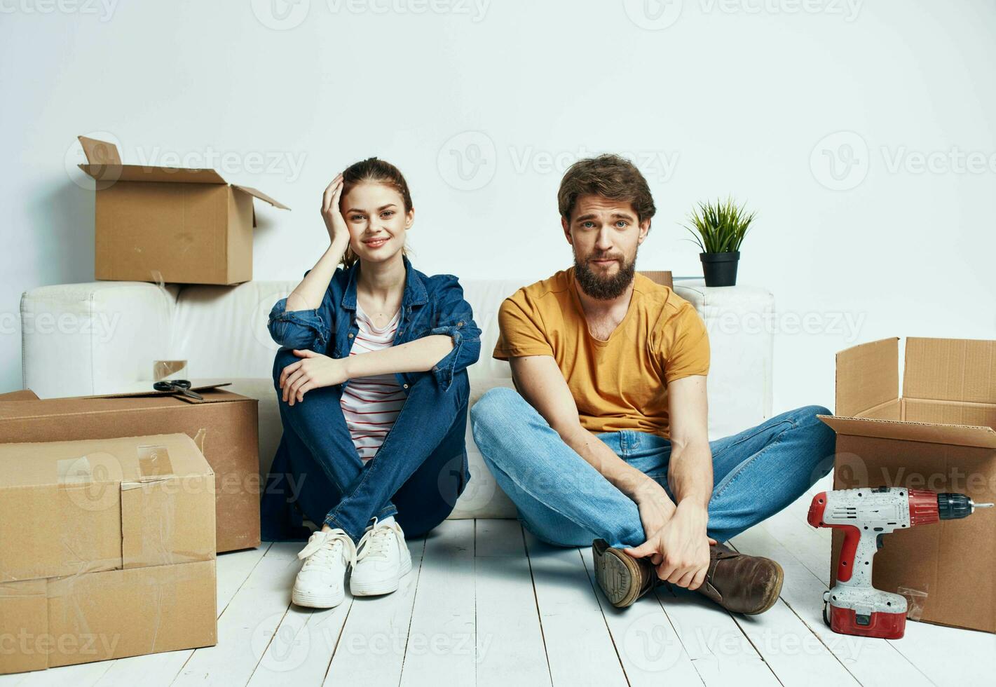 Man and woman with empty boxes Moving to an apartment indoor interior