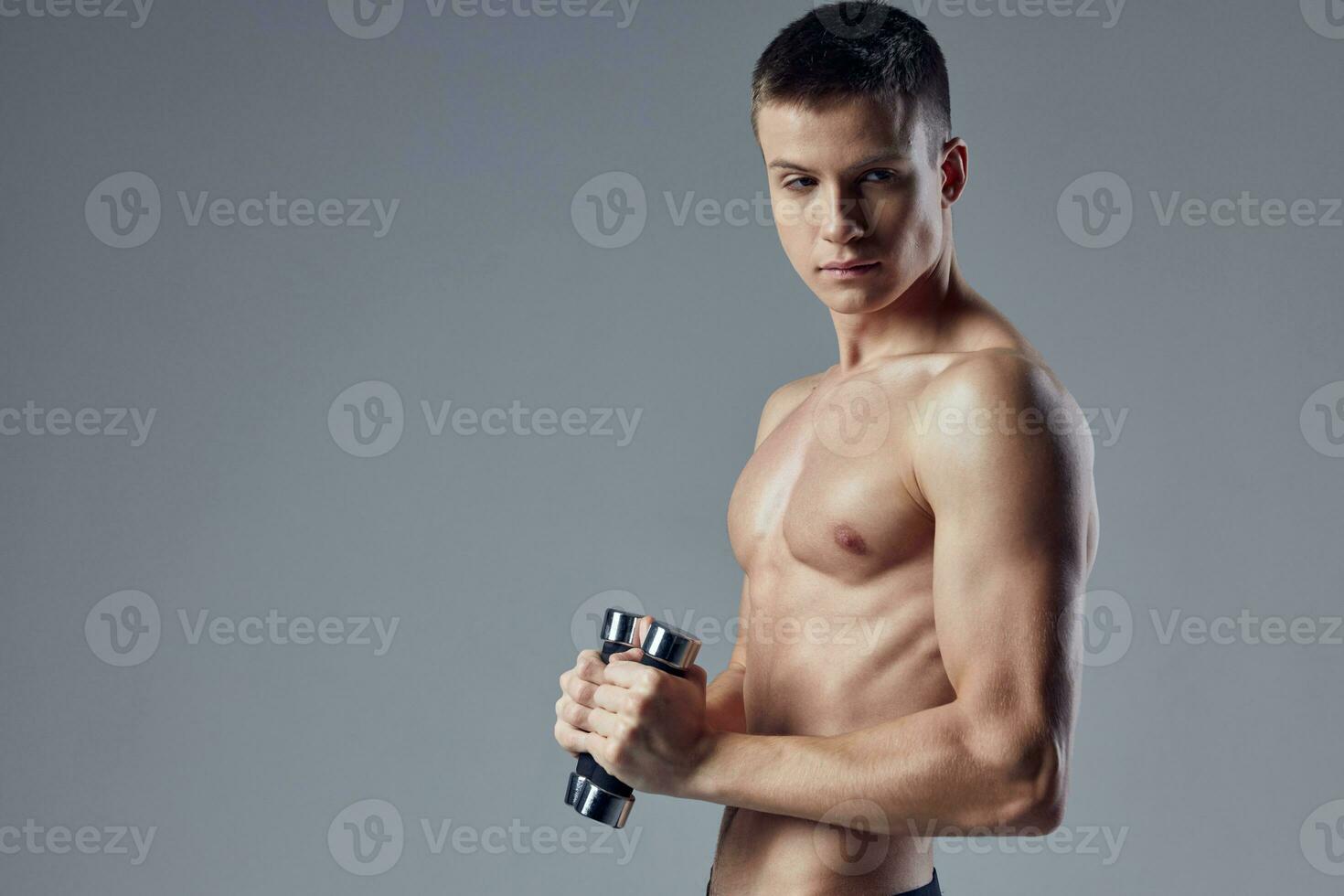sporty male athlete workout muscles exercise with dumbbells photo