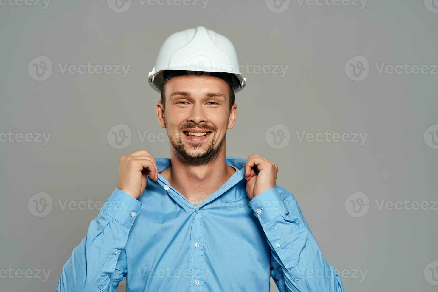 Cheerful male engineer in white construction helmet professional working photo