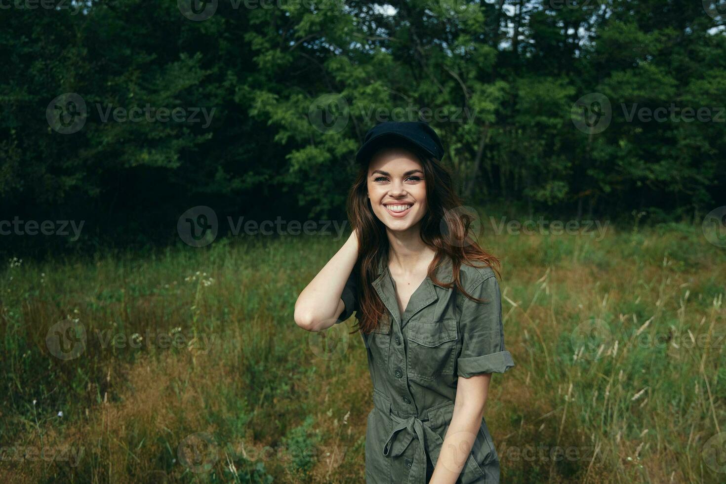 woman in the forest Cheerful smile black cap fresh air freedom green leaves photo