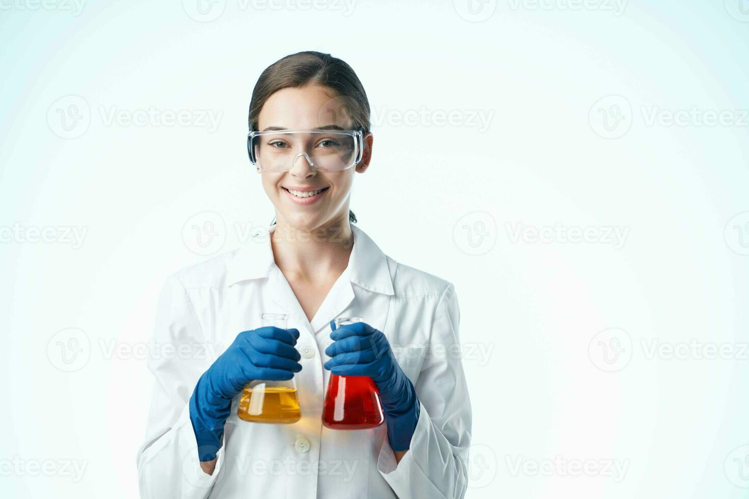 female laboratory assistant in white coat chemical solution research science photo