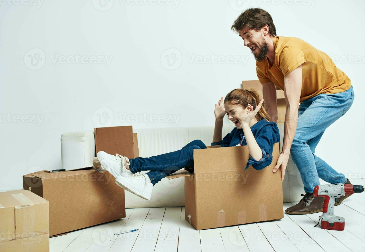 man and woman on white sofa interior cardboard boxes lifestyle photo