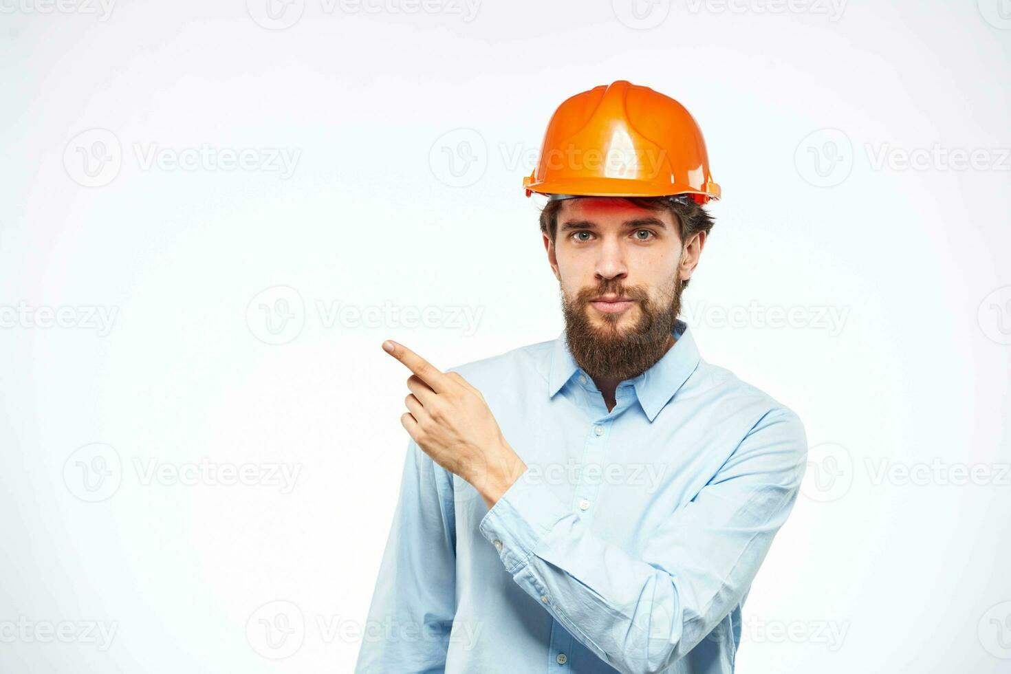 Man in orange hard hat industry engineer work professional light background photo
