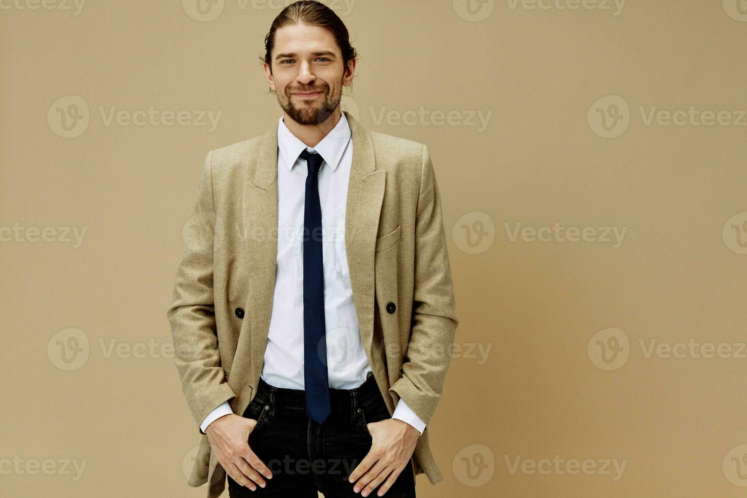 handsome man emotional man in suit gesture with hands beige background photo