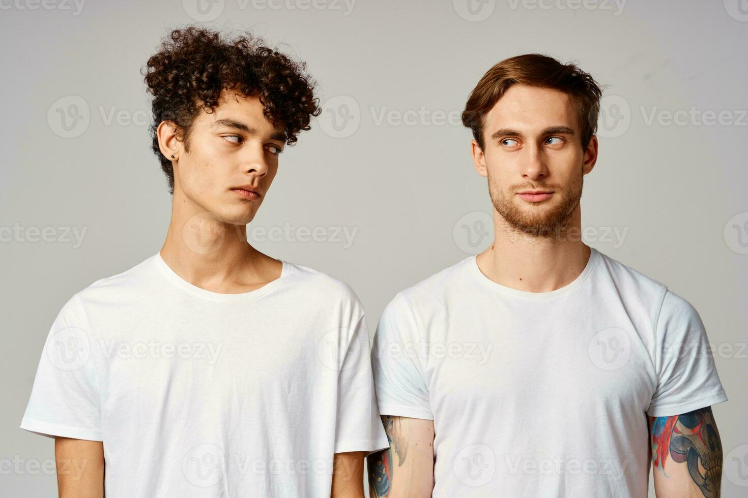 two friends in white t-shirts fun emotions isolated background photo