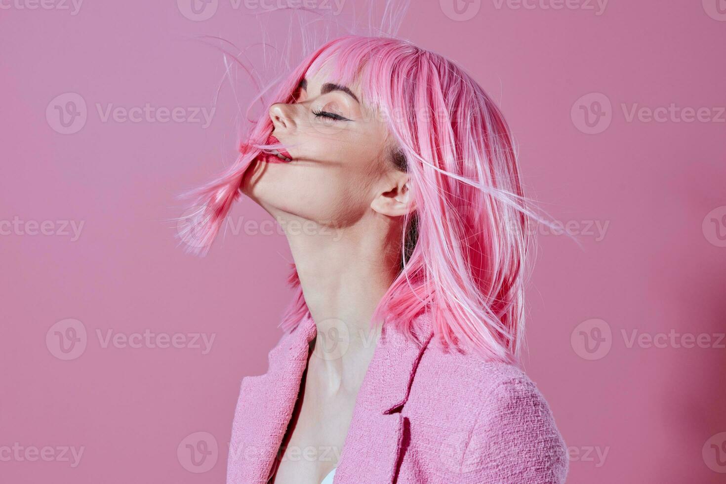 Young woman pink jacket holding hair cosmetics studio model unaltered photo