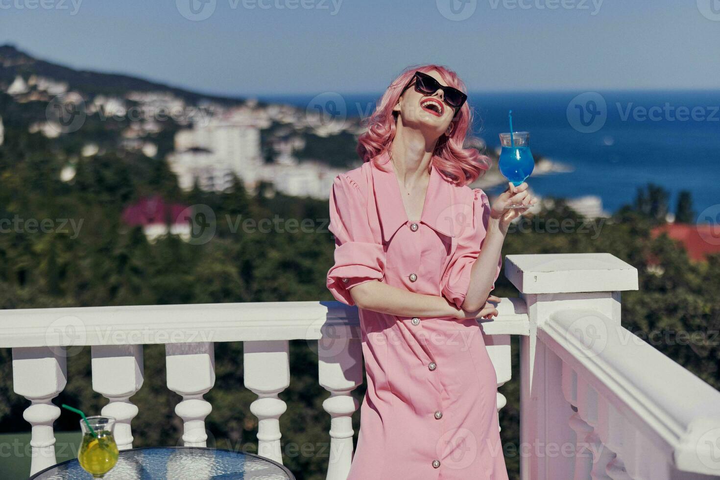portrait of beautiful woman in sunglasses outdoors on the terrace cocktail relaxing unaltered photo