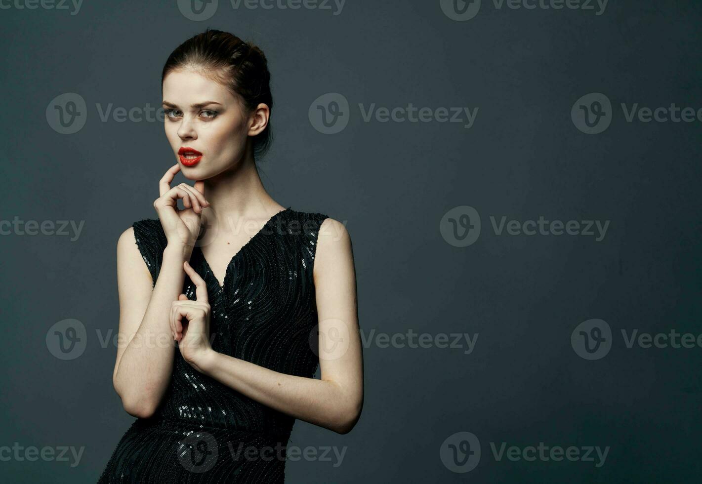 Lady in black dress with make-up puzzled look interested model photo