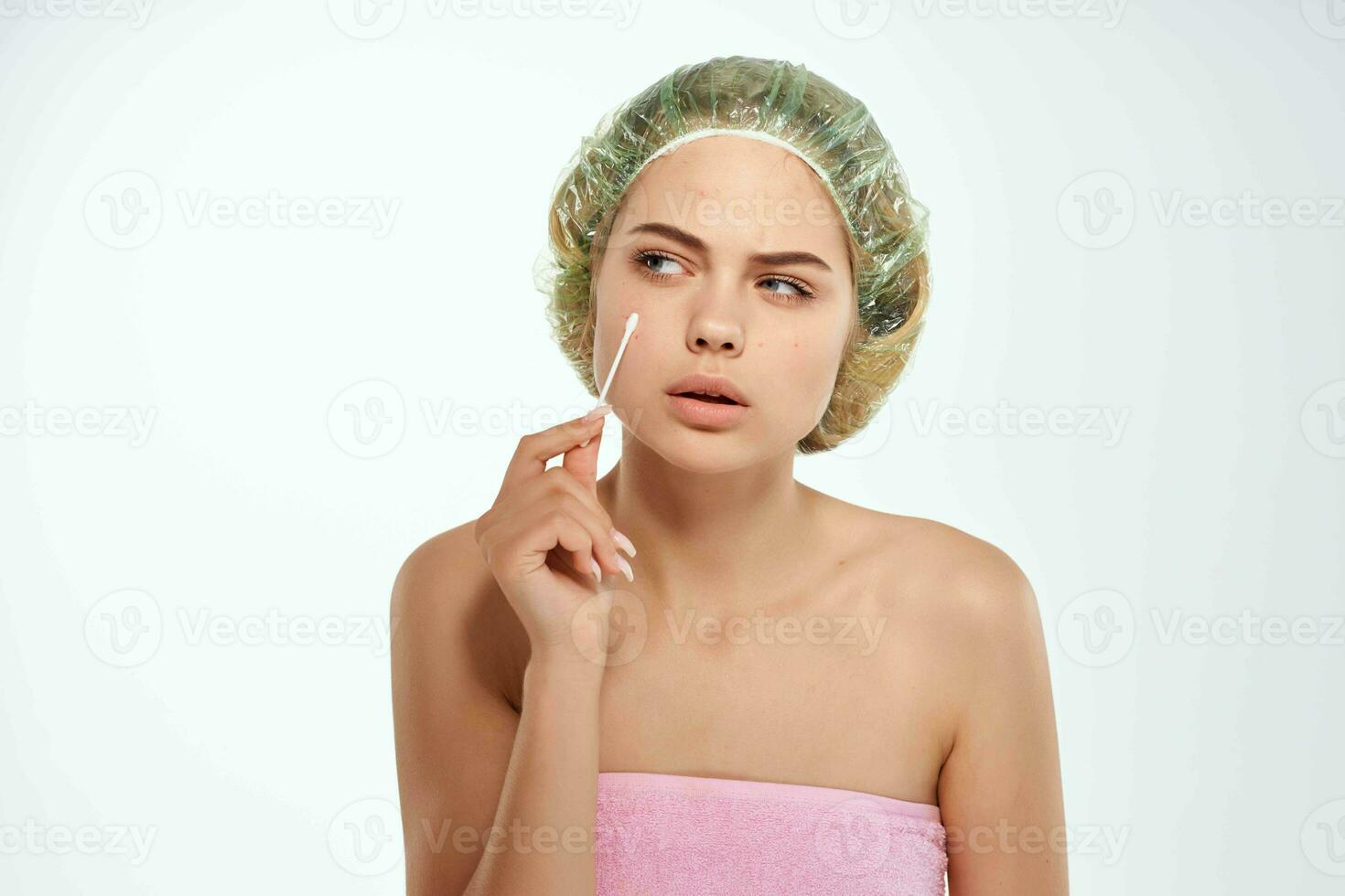 woman with bare shoulders clean skin pink towel face care photo
