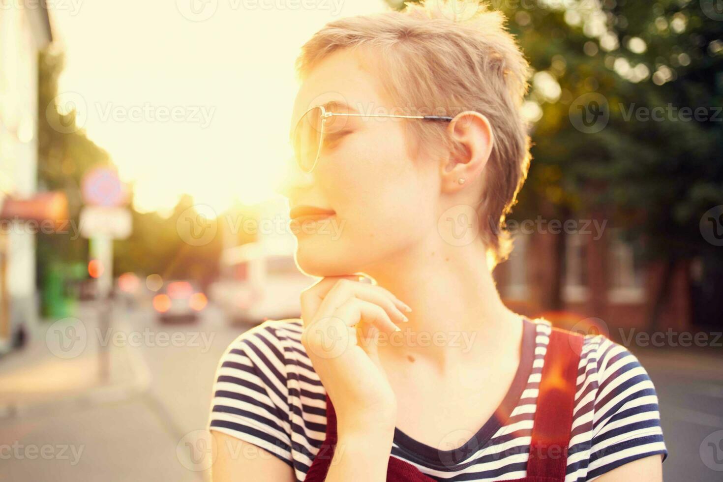 cheerful woman wearing sunglasses outdoors posing lifestyle photo