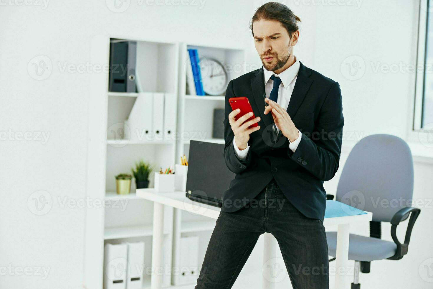 man in a suit in the office with documents lifestyle photo