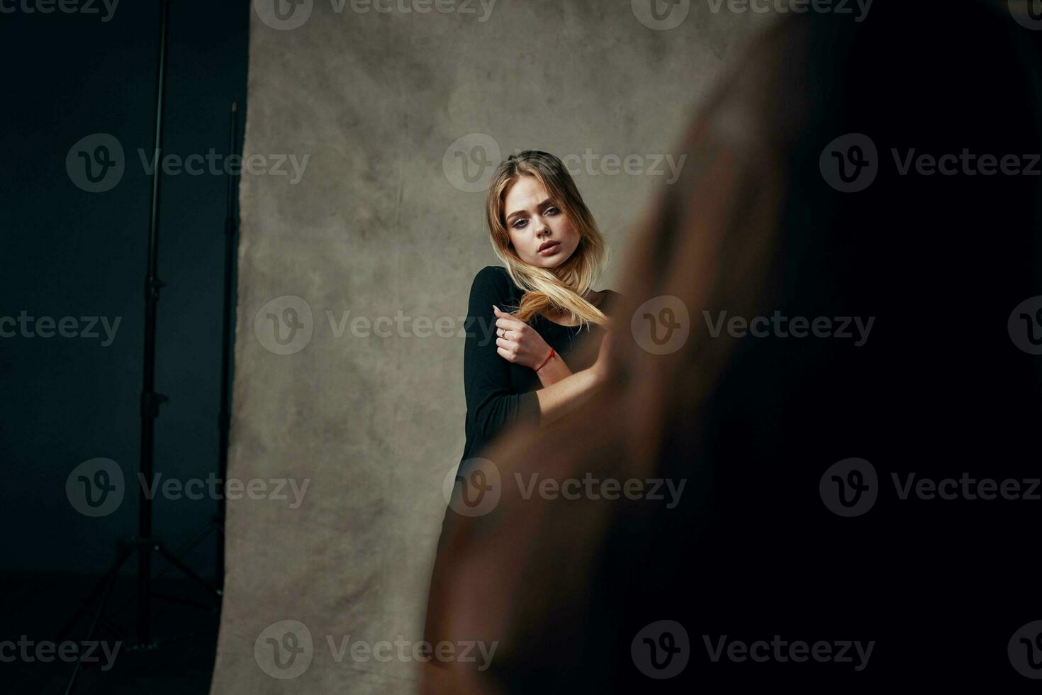 blonde girl in studio posing for photographer fashion lifestyle photo