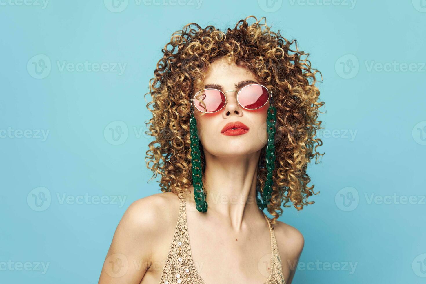 Portrait of a woman Curly hair jewelry studio glasses bright makeup photo