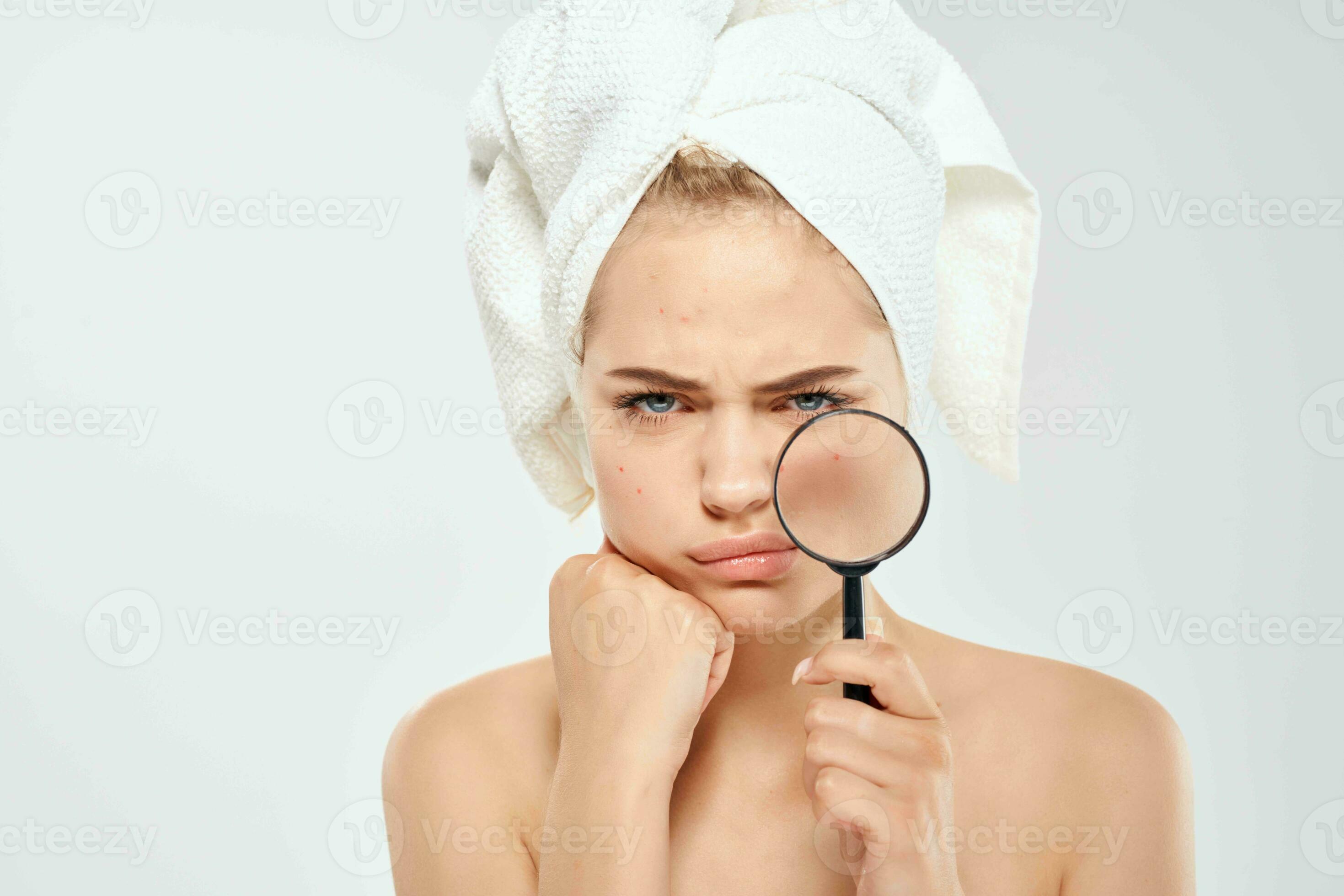 surprised woman with bare shoulders clean skin magnifying glass in