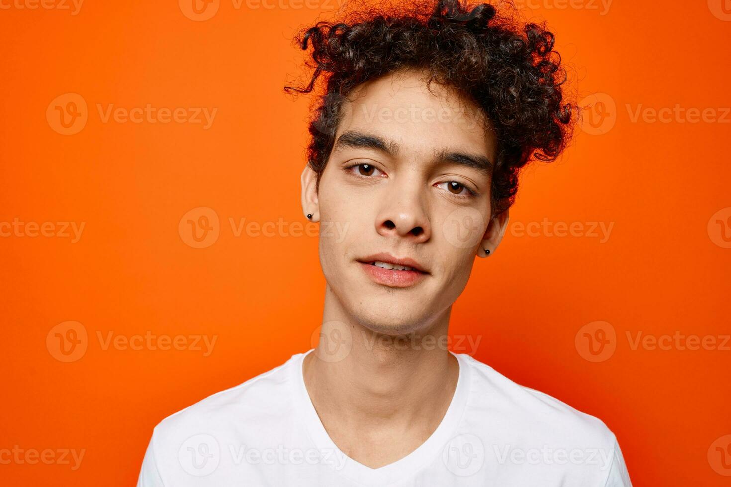 guy in white t-shirt curly hair cropped view studio photo