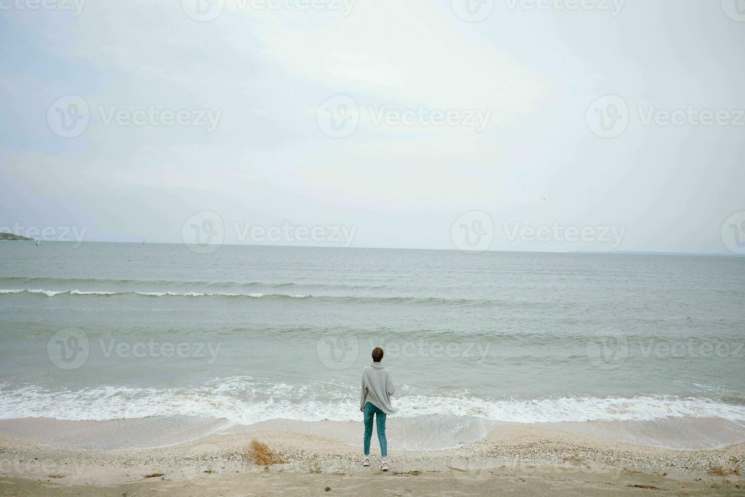 pretty woman alone by the ocean cloudy weather Happy female relaxing photo