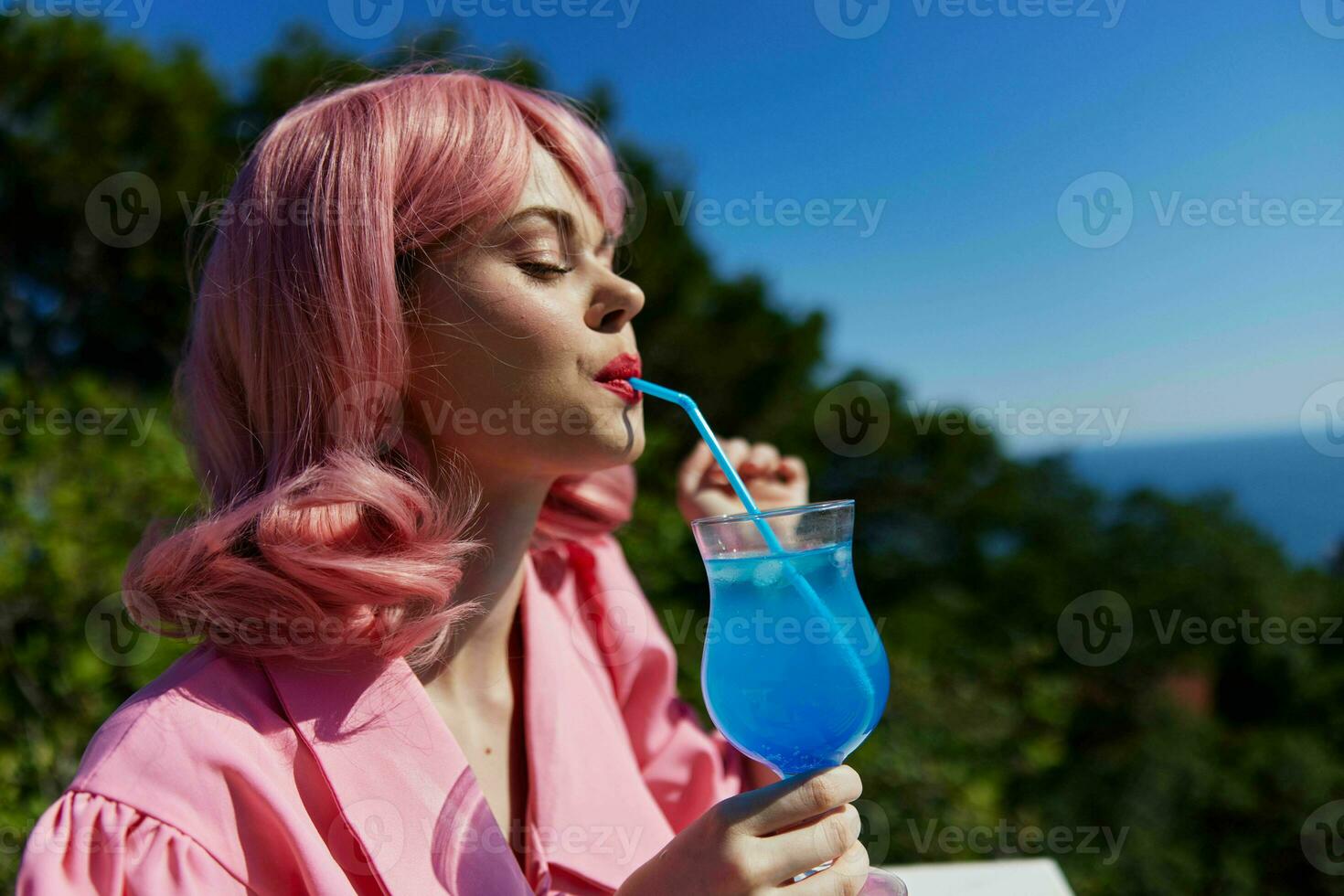 attractive woman with pink hair summer cocktail refreshing drink Relaxation concept photo