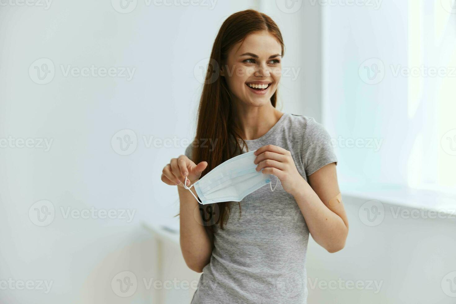 joyful woman medical mask vaccine passport quarantine photo